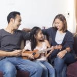 parents enjoying ukulele lessons with girl